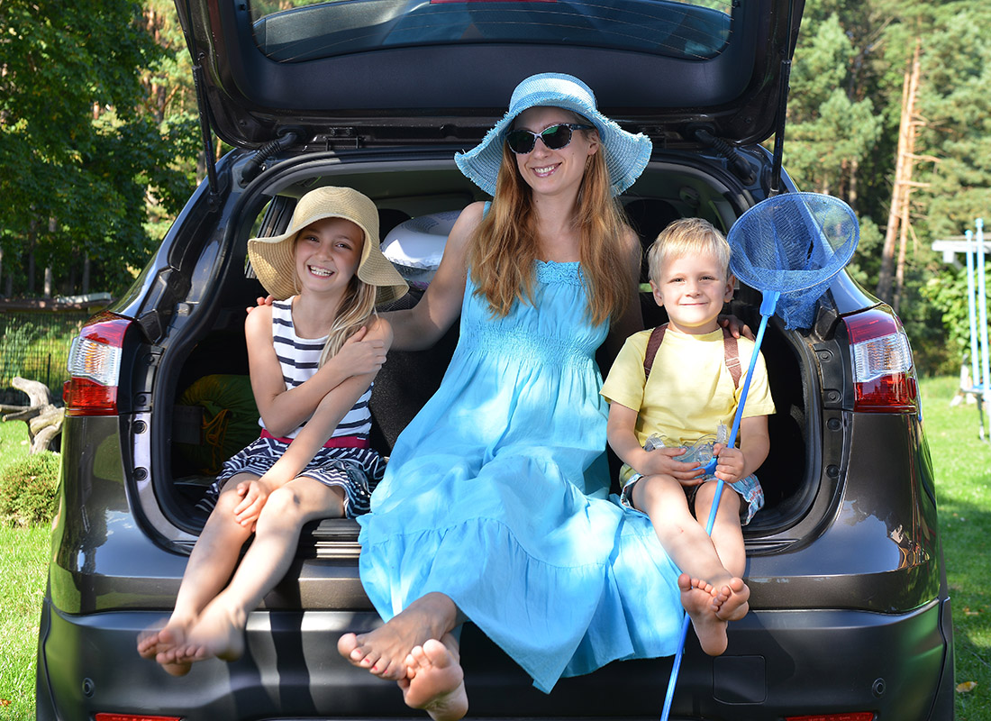 Personal Insurance - Mother and Kids Sitting in Back of Car at a Park